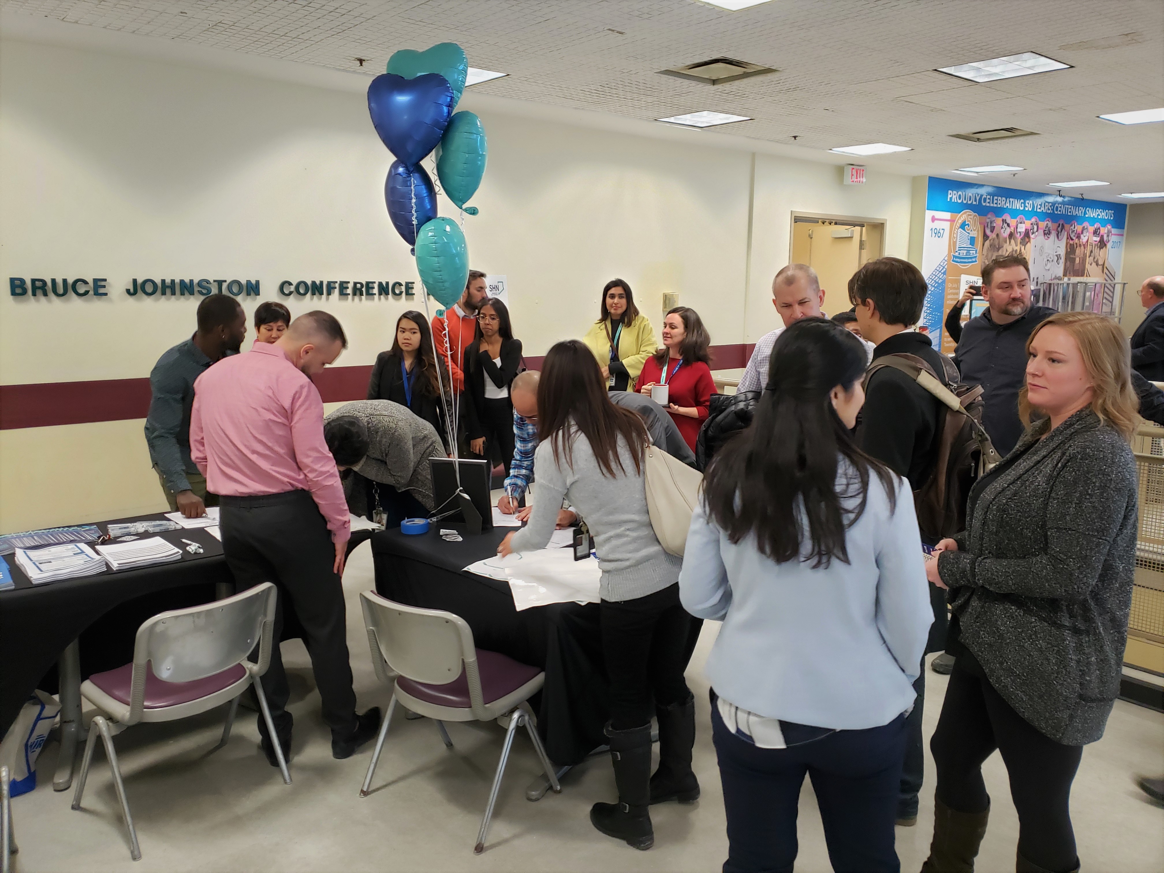 A crowd gathers to sign-up for the event before the opening remarks.