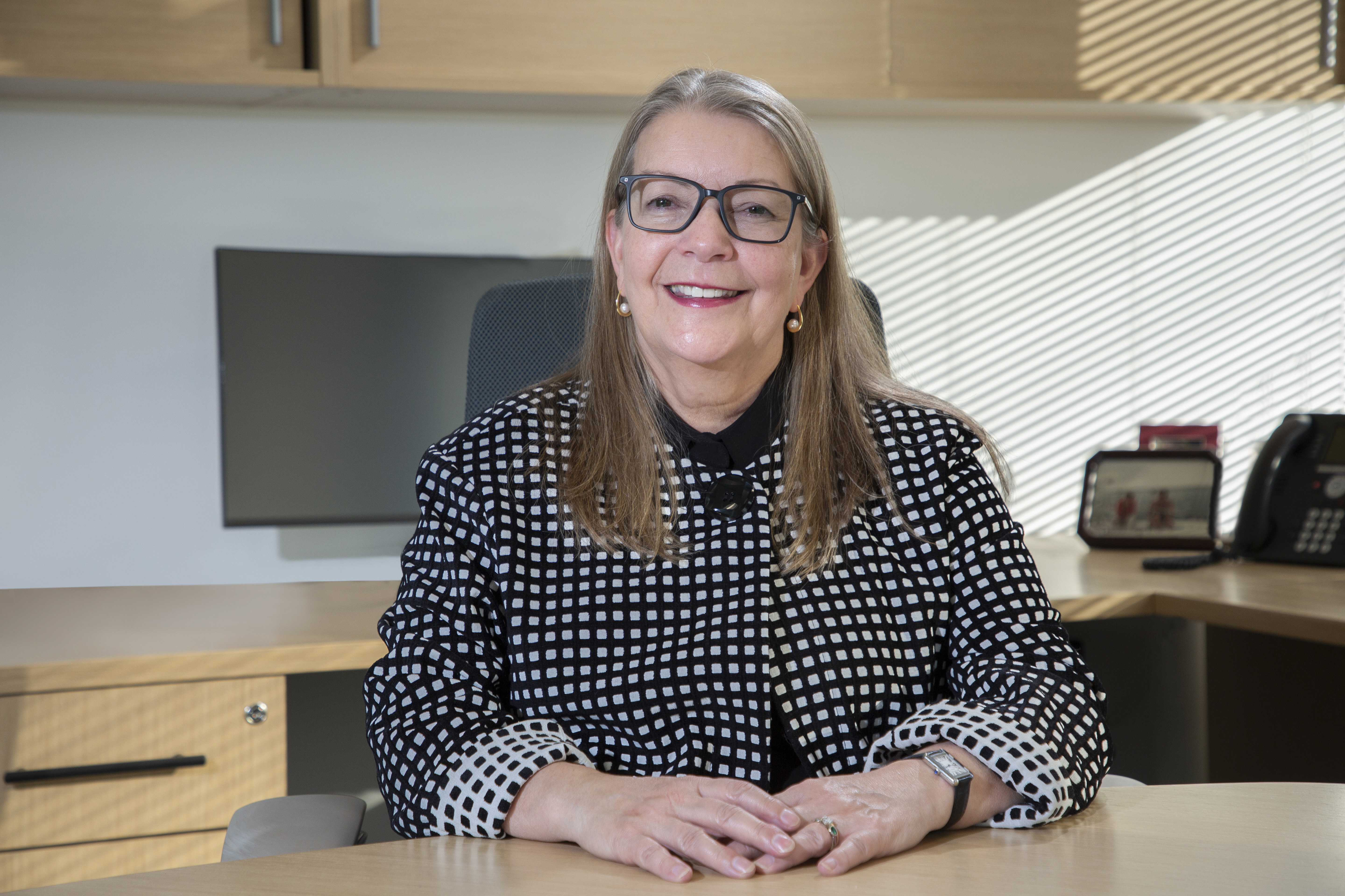 Catherine Gaulton at her desk, smiling