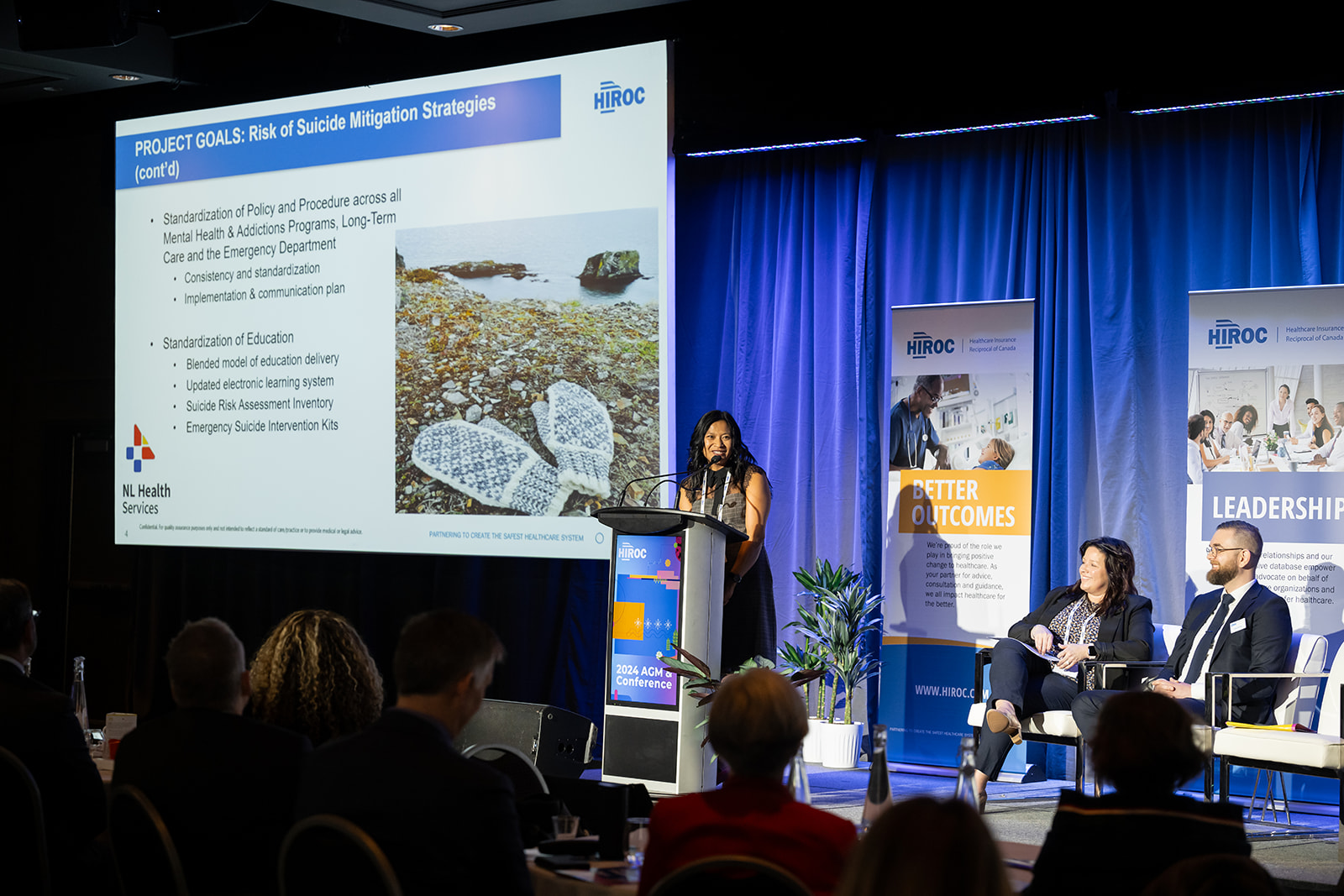 Mimie Carroll of NL Health Services speaks at the podium at HIROC's Annual Conference.