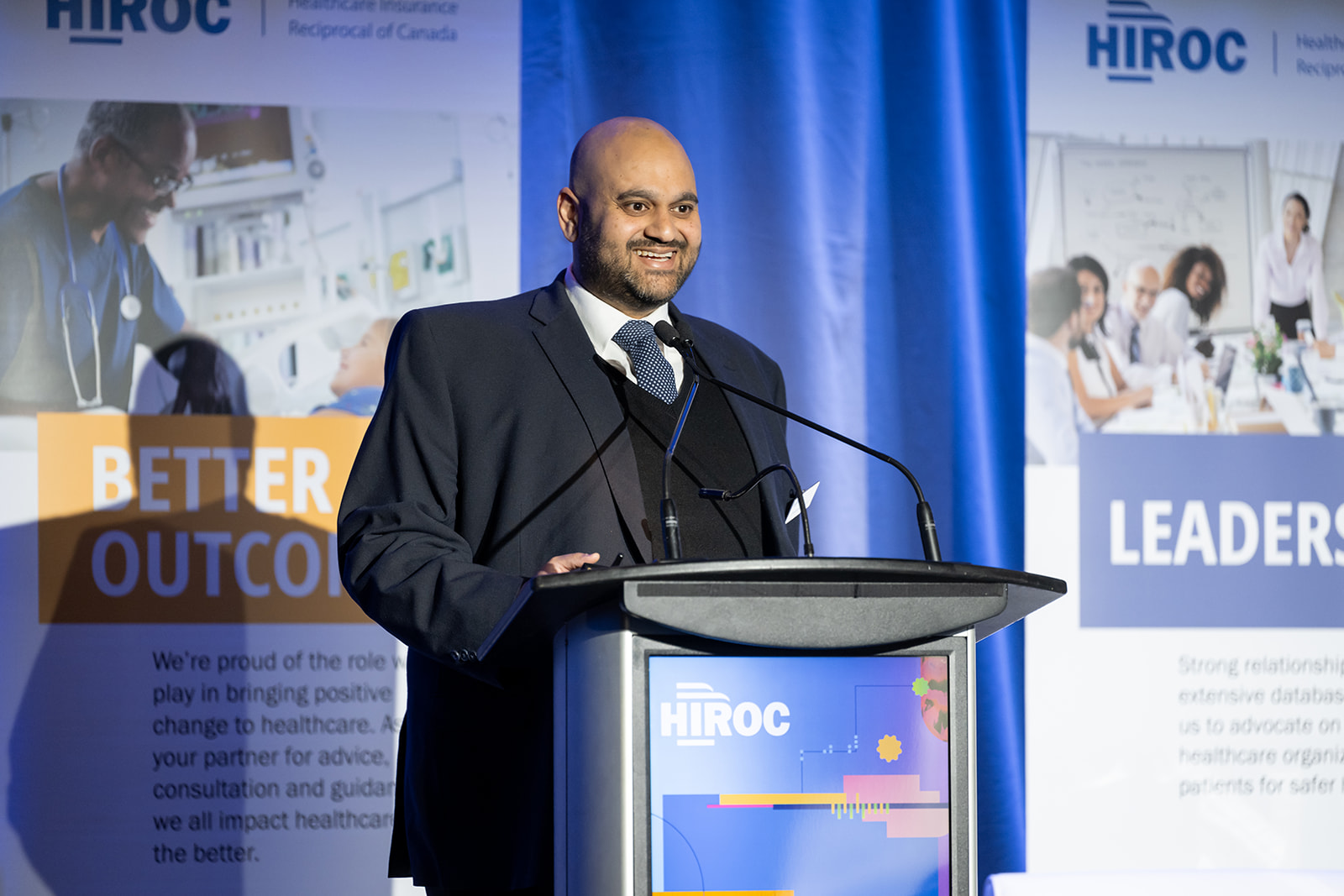 HIROC's Shahbaz Haque speaking at the podium.