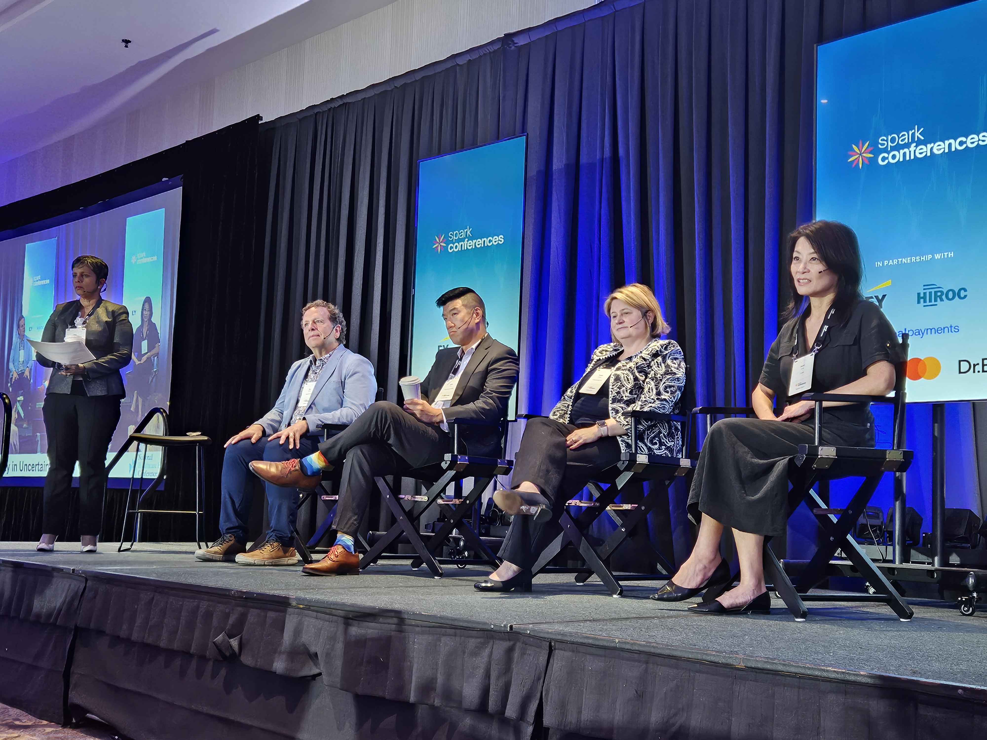 Panel speakers listen to a question on stage during their session.