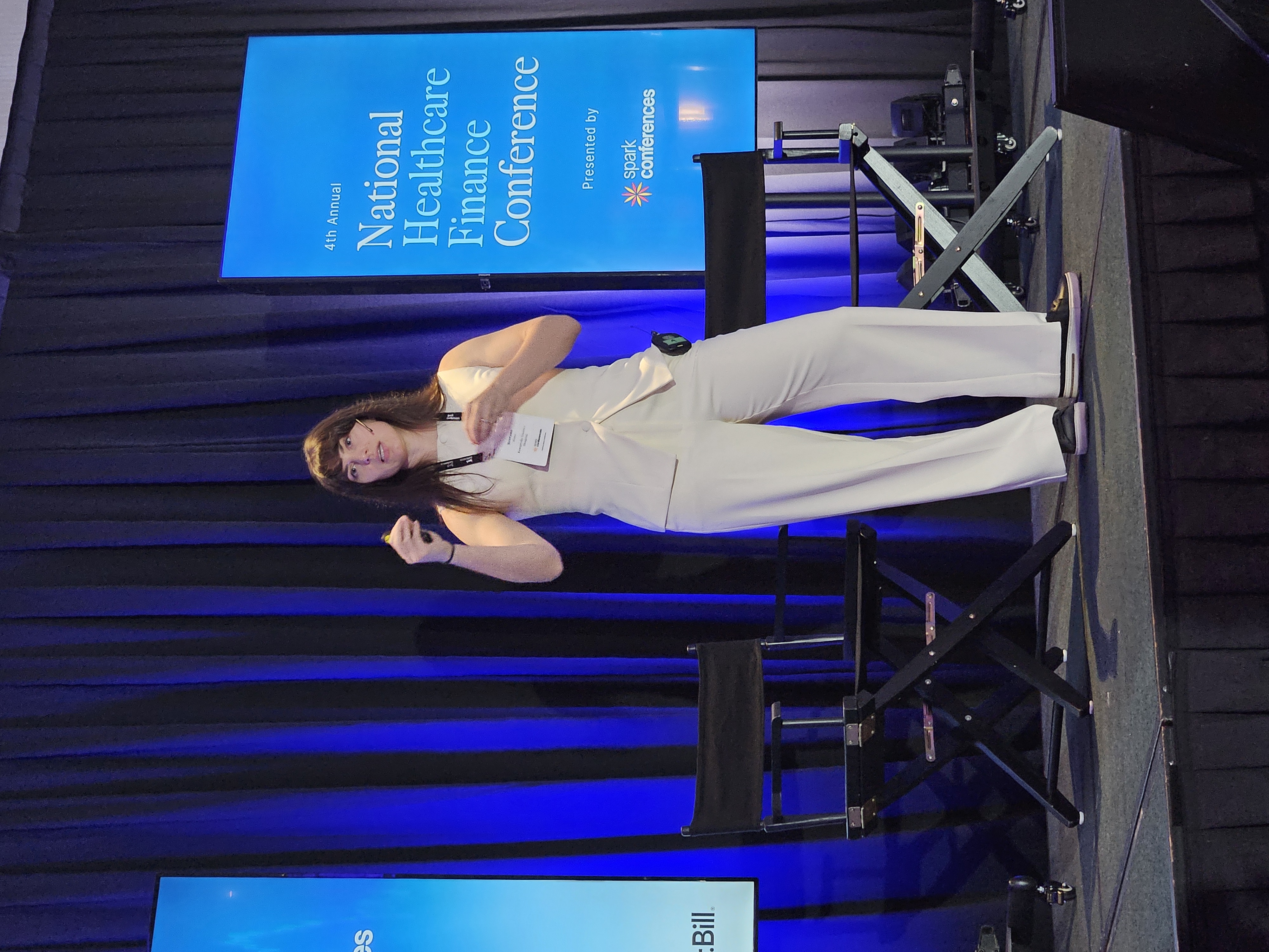 Brittany Rivard stands on stage during her talk.
