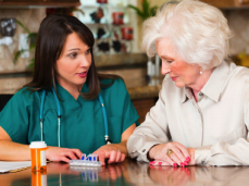Provider talking about medication with an elderly patient