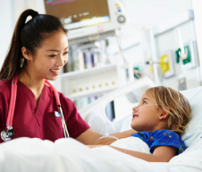 Provider talking to child in hospital bed