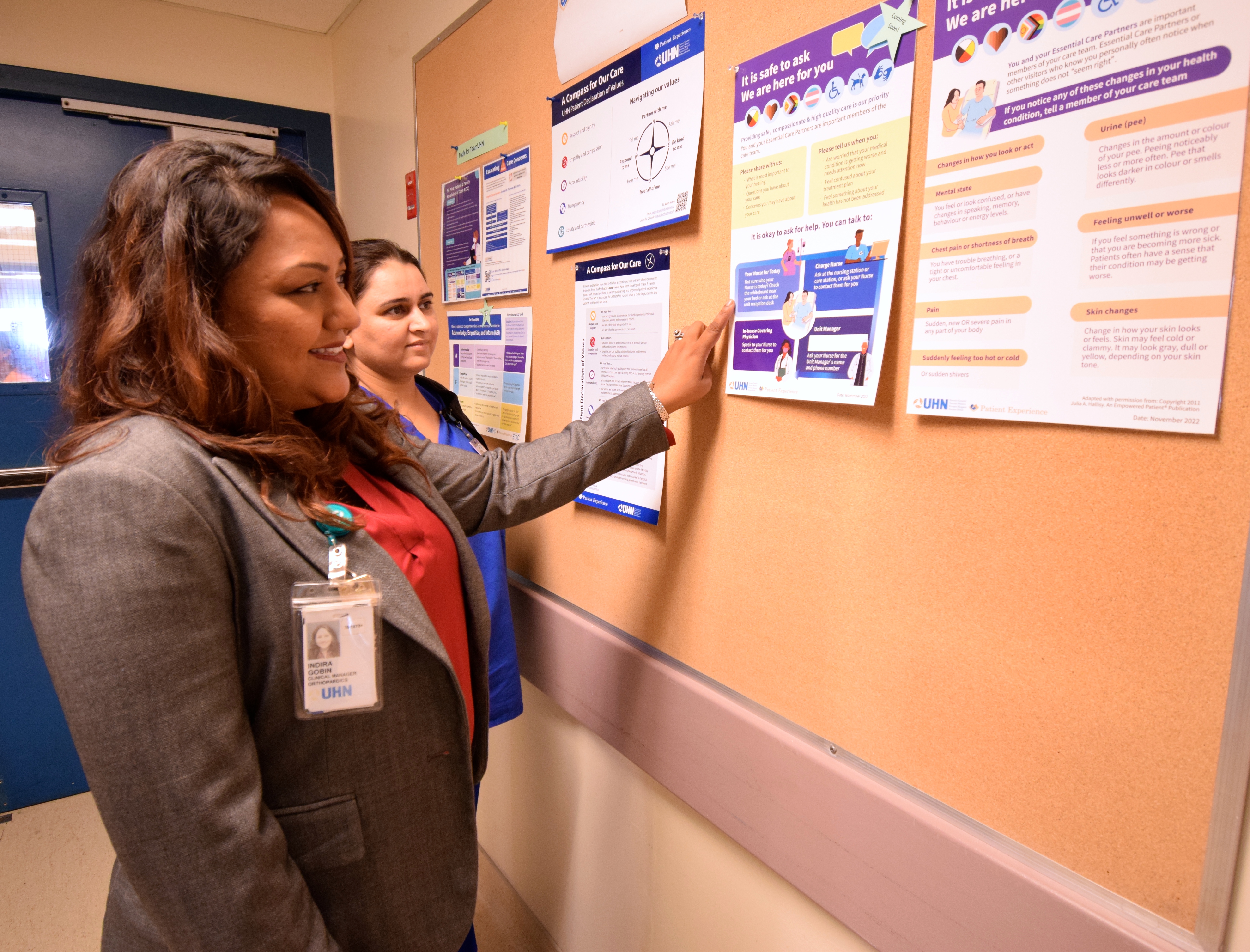 UHN staff looking at poster 