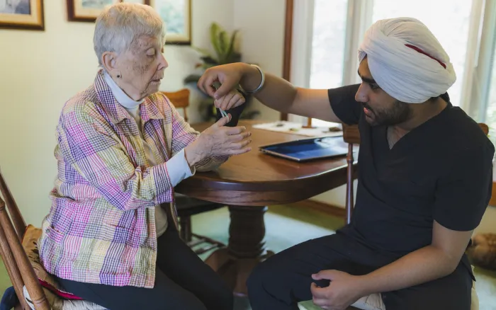 Bayshore Integrated Care Services physiotherapist Harmandeep Singh works with Mary-Jane Dolbear in her home.
