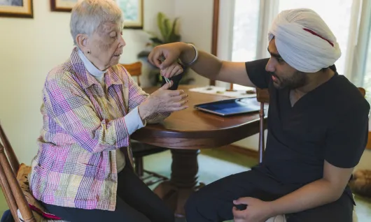 Bayshore Integrated Care Services physiotherapist Harmandeep Singh works with Mary-Jane Dolbear in her home.