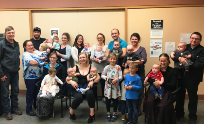 Dr. Ashley Dyson and Dr. Sahar Alhayjaa with a number of families that were able to deliver their twins at BTHC. Photo courtesy of Heather Coutts at Salus Global.