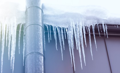 Image of frozen pipe on a building, ice hanging off