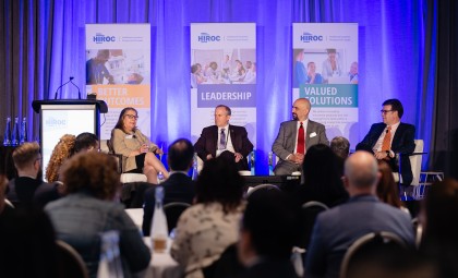 Photo of catherine gaulton, cameron love, mike nader, and steve ashton speaking on stage at the 2023 HIROC Conference