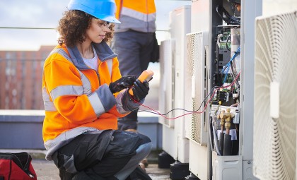 An HVAC technician repairing an AC unit