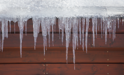 A header image depicting a photo of icicles hanging from the side of a structure with wood panels.