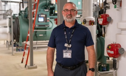 Photo of Chris Mackey standing in front of some equipment at Providence
