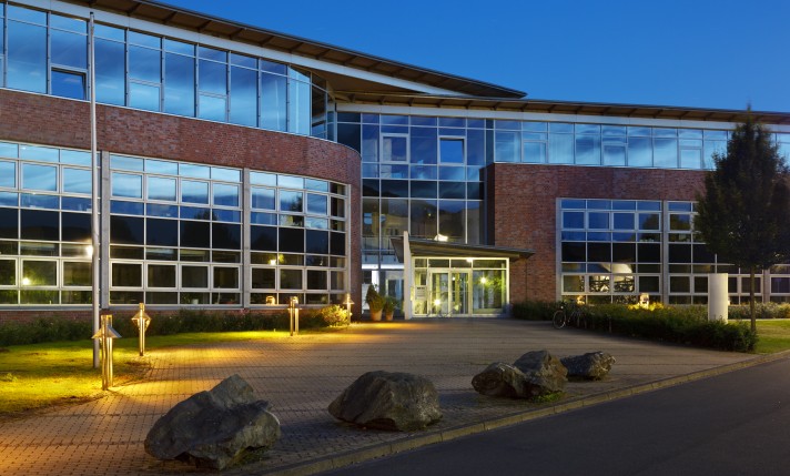 Image of a facility like a hospital at night, facility is well lit.