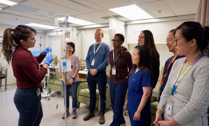 A staff member from MGH's Oncology & Hematology Clinic showcases an IV safety measure for the rest of the team.