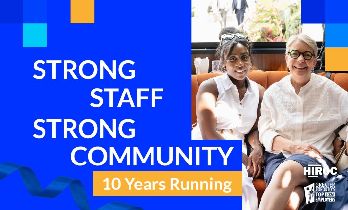 Image reading "strong staff, strong community, 10 years running" featuring photo of 2 employees sitting down and smiling at camera